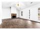 Bright and inviting living space featuring wood-look tile flooring and a stone fireplace at 25 Woodland Ridge Cir, Covington, GA 30016