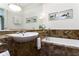 Clean bathroom with marble tile and a built-in bathtub at 1020 W Wesley Nw Rd, Atlanta, GA 30327