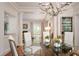 Elegant dining room with a glass-top table and chandelier at 1020 W Wesley Nw Rd, Atlanta, GA 30327