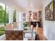 Bright dining room with glass table and wicker chairs, overlooking a lush garden at 1020 W Wesley Nw Rd, Atlanta, GA 30327