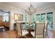 Formal dining room with a glass-top table and hardwood floors at 1020 W Wesley Nw Rd, Atlanta, GA 30327