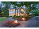 Stunning home exterior with landscaped gardens and a lighted walkway at 1020 W Wesley Nw Rd, Atlanta, GA 30327
