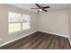 Bedroom with wood floors, a large window and ceiling fan at 3446 Newberry Trl, Decatur, GA 30034