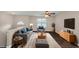 Furnished living room with dark hardwood floors, a ceiling fan, and large TV at 3446 Newberry Trl, Decatur, GA 30034