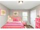 Charming bedroom with pink bedding, a window, and a bookshelf at 3457 Sardis Bend Dr, Buford, GA 30519