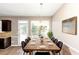 Bright dining room features a large wooden table, six chairs, and a chandelier at 3457 Sardis Bend Dr, Buford, GA 30519