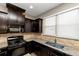 Kitchen features dark cabinets, granite countertops, and a gas range at 3457 Sardis Bend Dr, Buford, GA 30519