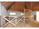 Well-lit barn area showing wooden features, cinder block, and windows, presenting a rustic aesthetic with renovation potential at 115 Russell Rd, Roswell, GA 30075