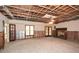 Spacious unfinished basement with exposed ceiling, fireplace, and potential for customization at 115 Russell Rd, Roswell, GA 30075