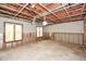 Large unfinished basement area with exposed ceiling and natural light from the windows at 115 Russell Rd, Roswell, GA 30075