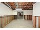 Spacious unfinished basement with exposed framing and utilities, offering renovation potential at 115 Russell Rd, Roswell, GA 30075