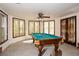 Basement with a pool table, multiple windows, and natural light at 115 Russell Rd, Roswell, GA 30075