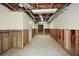 Spacious unfinished basement with exposed framing and utilities, offering renovation potential at 115 Russell Rd, Roswell, GA 30075