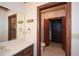 Bathroom featuring a vanity area leading to a walk-in closet and toilet at 115 Russell Rd, Roswell, GA 30075