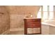 This bathroom includes a vanity featuring a storage drawer, cabinet, and beautiful wallpaper, creating a luxurious space at 115 Russell Rd, Roswell, GA 30075