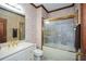 Bathroom with gold fixtures, glass enclosed shower, and floral wallpaper at 115 Russell Rd, Roswell, GA 30075