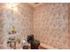 Unique powder room featuring designer wallpaper, stylish vessel sink, and a black toilet at 115 Russell Rd, Roswell, GA 30075