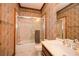 Bathroom with a bathtub and shower combo and patterned wallpaper at 115 Russell Rd, Roswell, GA 30075