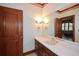 Bathroom featuring a large mirror, white countertop, and traditional fixtures at 115 Russell Rd, Roswell, GA 30075
