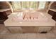 This luxurious bathroom features a soaking tub with gold fixtures, surrounded by custom cabinets and a serene window view at 115 Russell Rd, Roswell, GA 30075