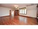Bright bedroom featuring hardwood floors, a large window, and built-in bookcases at 115 Russell Rd, Roswell, GA 30075