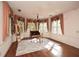 Bedroom featuring hardwood floors, large windows, and decorative window treatments at 115 Russell Rd, Roswell, GA 30075
