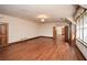 Bright bedroom featuring hardwood floors, a large window, and ample space at 115 Russell Rd, Roswell, GA 30075