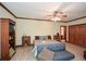 Spacious bedroom featuring a ceiling fan, wood trim, and hardwood flooring at 115 Russell Rd, Roswell, GA 30075