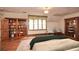 Cozy bedroom with built-in bookshelves, hardwood floors, and a window seat at 115 Russell Rd, Roswell, GA 30075