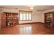 Bedroom with hardwood floors, large windows, built-in bookcases, and natural light at 115 Russell Rd, Roswell, GA 30075