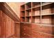 Rustic walk-in closet boasts custom wood shelving and drawers, offering ample storage in a cozy, cabin-like atmosphere at 115 Russell Rd, Roswell, GA 30075