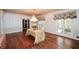Spacious dining room with hardwood floors, chandelier, bright windows, and elegant wainscoting at 115 Russell Rd, Roswell, GA 30075