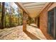 Brick covered porch with supports along the back of the house at 115 Russell Rd, Roswell, GA 30075