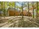 Sprawling brick home showcasing elegant architecture and surrounded by mature trees in a natural setting at 115 Russell Rd, Roswell, GA 30075