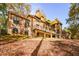 Stately brick home on a wooded lot with colorful fall foliage at 115 Russell Rd, Roswell, GA 30075
