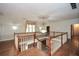 Foyer with wood floors, white railings, a chandelier, and natural light from the large window at 115 Russell Rd, Roswell, GA 30075