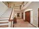 Grand foyer with hardwood floors, staircase, and soaring ceilings at 115 Russell Rd, Roswell, GA 30075