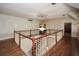 Foyer featuring wood floors, decorative wall niches, a chandelier, and white railings at 115 Russell Rd, Roswell, GA 30075