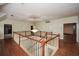 Open foyer with wood floors, a chandelier, white railings, and multiple doorways at 115 Russell Rd, Roswell, GA 30075