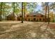 Large brick home with mature trees and landscaping at 115 Russell Rd, Roswell, GA 30075