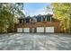 Spacious four-car garage with brick exterior, perfect for car enthusiasts or extra storage at 115 Russell Rd, Roswell, GA 30075