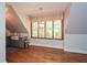 Eat in kitchen displays hardwood floors, gray cabinets, and lots of natural light at 115 Russell Rd, Roswell, GA 30075