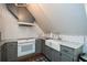 This kitchen showcases a white farmhouse sink, stainless faucet, gray cabinets, and modern appliances at 115 Russell Rd, Roswell, GA 30075