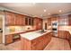 Bright kitchen featuring custom wood cabinets, stainless appliances, a center island, and under cabinet lighting at 115 Russell Rd, Roswell, GA 30075
