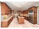Spacious kitchen with custom wood cabinets, stainless steel appliances, and a brick-patterned floor at 115 Russell Rd, Roswell, GA 30075
