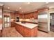 Spacious kitchen with wood cabinets, stainless appliances, a center island, and lots of lighting at 115 Russell Rd, Roswell, GA 30075