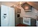Cozy kitchen features updated appliances, subway tile backsplash, and gray cabinetry at 115 Russell Rd, Roswell, GA 30075