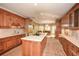 Open kitchen with custom wood cabinets, stainless steel appliances, island, and cozy seating area at 115 Russell Rd, Roswell, GA 30075