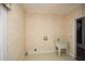 Utility room with a standalone sink, neutral walls, and tile flooring at 115 Russell Rd, Roswell, GA 30075