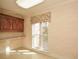 Bright laundry room with ample counter space, storage cabinets, and a large window at 115 Russell Rd, Roswell, GA 30075